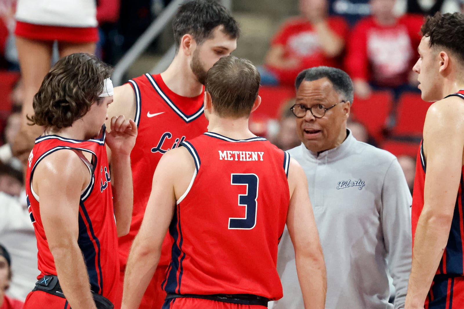 Liberty head coach Ritchie McKay talks to his team during a time out against North Carolina State during the first half of an NCAA college basketball game in Raleigh, N.C., Wednesday, Dec. 10, 2025. (AP Photo/Karl DeBlaker)