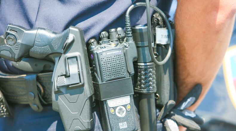 Fairfield Police officer Scott Webb displays his radio outside the police station, Wednesday, Aug. 2, 2017. Butler County officials and police and fire departments across the county are looking at a $19.2 million price tag to replace parts of the 800 MHz communications systems, including the radios first responders carry.GREG LYNCH / STAFF