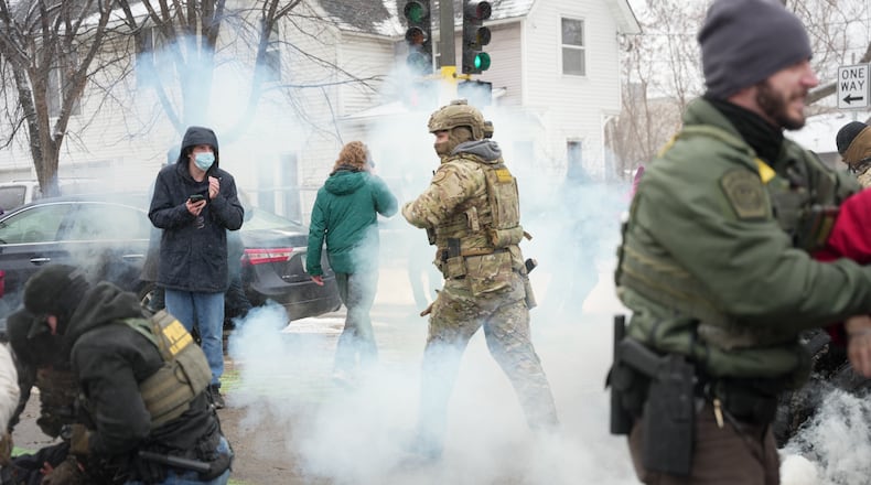 Tear gas is deployed as Federal agents make arrests on Wednesday, Jan. 21, 2026, in Minneapolis. (AP Photo/Angelina Katsanis)