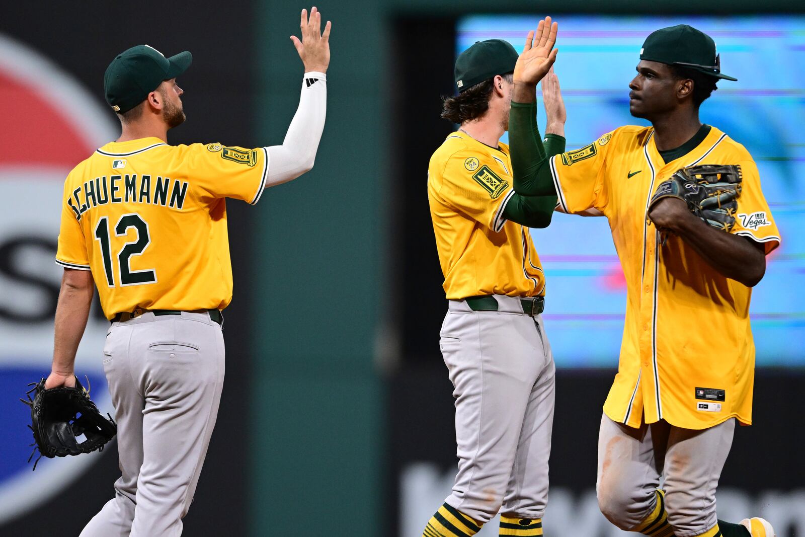 Athletics center fielder Denzel Clarke, right, is congratulated by second basemen Max Schuemann (12) after their team defeated the Cleveland Guardians in a baseball game, Saturday, July 19, 2025, in Cleveland. (AP Photo/David Dermer)