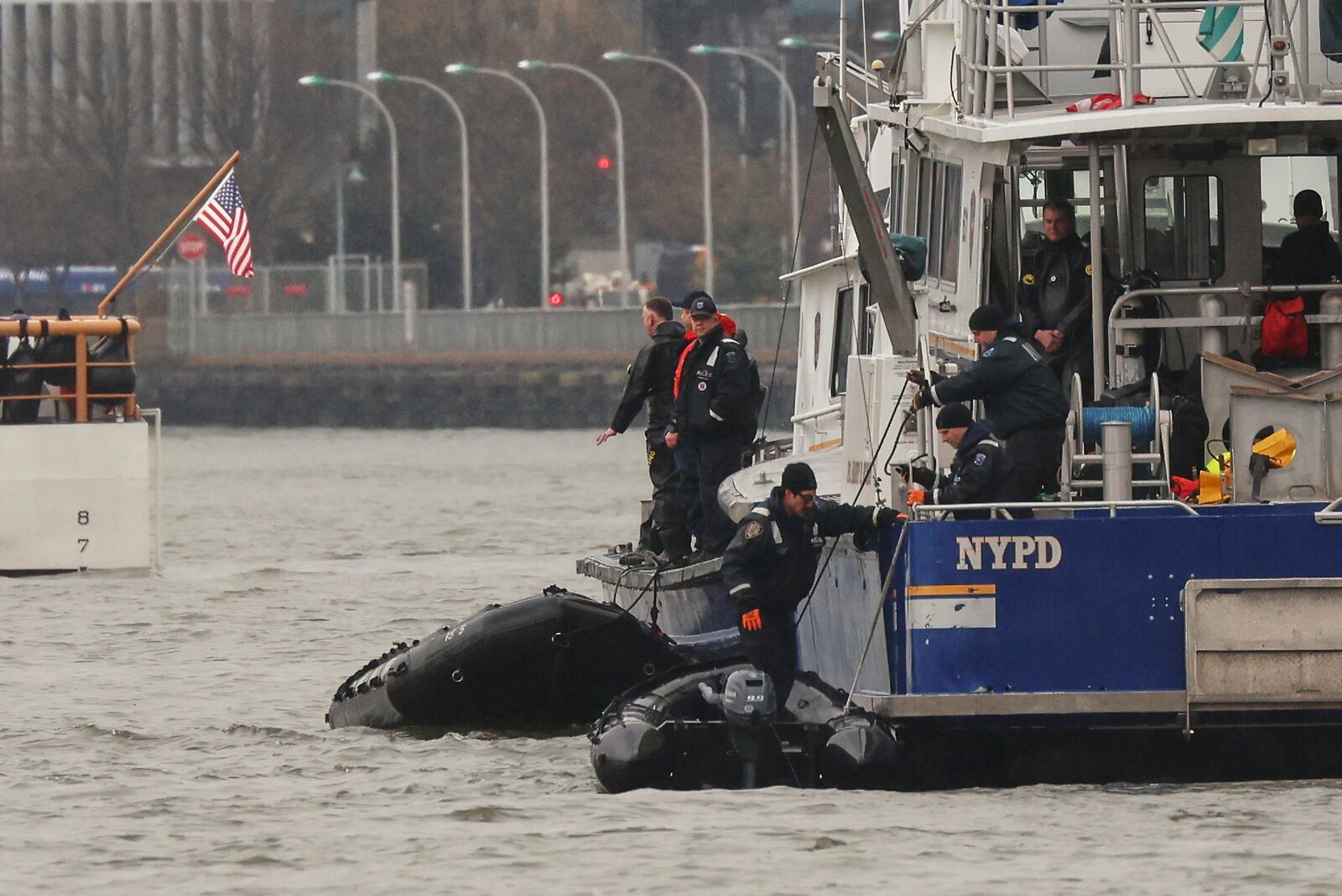 A New York Police Department scuba team prepares to dive, Friday, April 11, 2025, where a sightseeing helicopter crashed a day earlier into the Hudson River in Jersey City, N.J. (AP Photo/Yuki Iwamura)