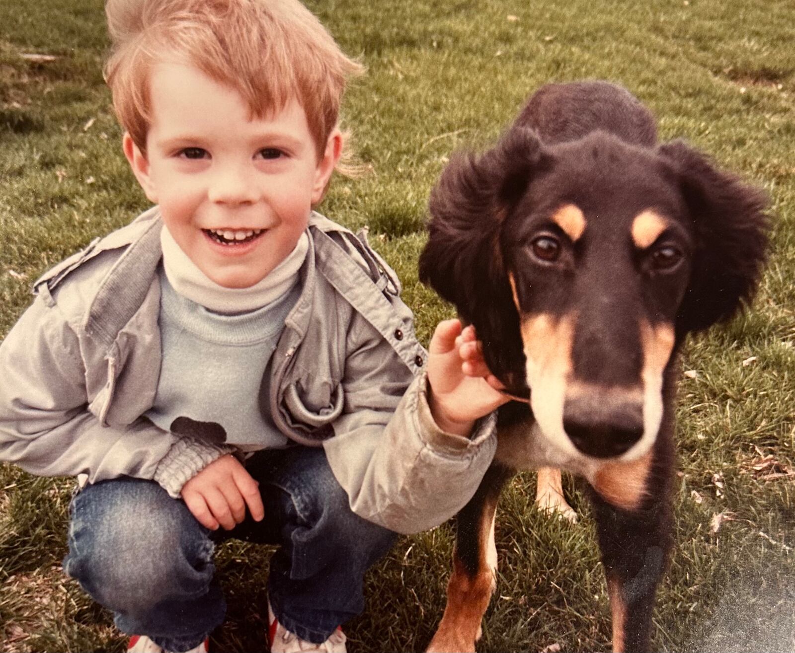 Omer at age 4 in 1984 with a friend's dog. He said he has loved dogs for as long as he can remember. CONTRIBUTED