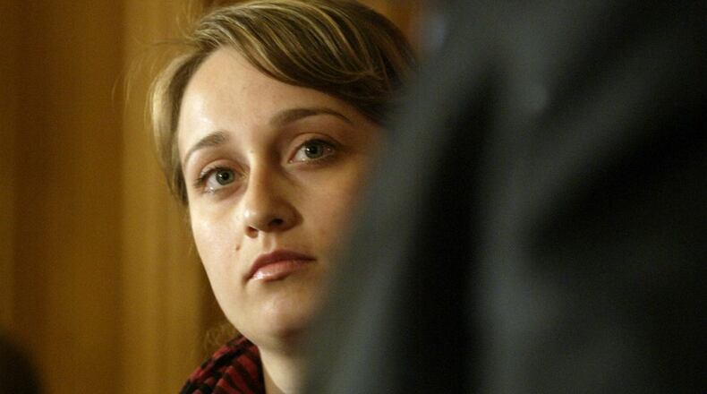 Mavilya Chubarova, a woman who former Attorney General Marc Dann raised as a daughter, watches as Dann resigns Wednesday May 14, 2008, in Columbus. Dann is one of the public officials in Ohio who has run afoul of the state’s ethics laws. LISA POWELL/STAFF