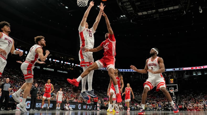 Houston's Mercy Miller (25) shoots over Arizona's Motiejus Krivas (13) during the first half of an NCAA college basketball game in the championship of the Big 12 Conference tournament Saturday, March 14, 2026, in Kansas City, Mo. (AP Photo/Charlie Riedel)