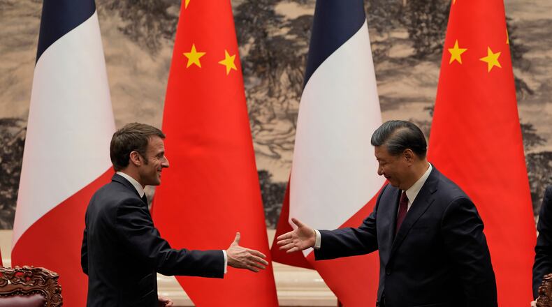 FILE - French President Emmanuel Macron, left, shakes hands with Chinese President Xi Jinping after meeting the press at the Great Hall of the People in Beijing on April 6, 2023. (AP Photo/Ng Han Guan, Pool, File)