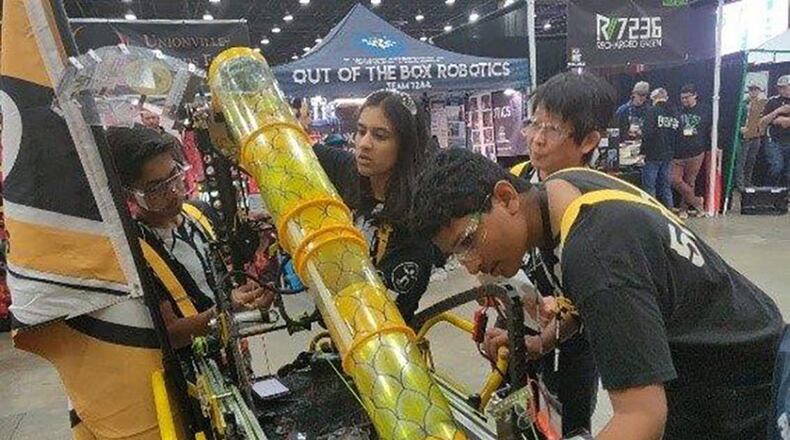 The Powerstackers, a FIRST Tech Challenge robot building team from Dayton checks over their robot during a competition. After a season of competing in events in West Virginia, Indiana and Ohio, the team took home second place from the First championship in Detroit in April. (Courtesy photo)
