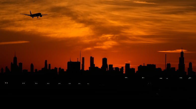An airplane descends to land at O'Hare International Airport in Chicago, Wednesday, Nov. 12, 2025. (AP Photo/Nam Y. Huh)