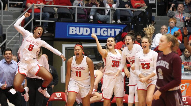 Dayton players cheer on the bench after a basket in the fourth quarter against Colgate on Friday, Nov. 9, 2018, at UD Arena.