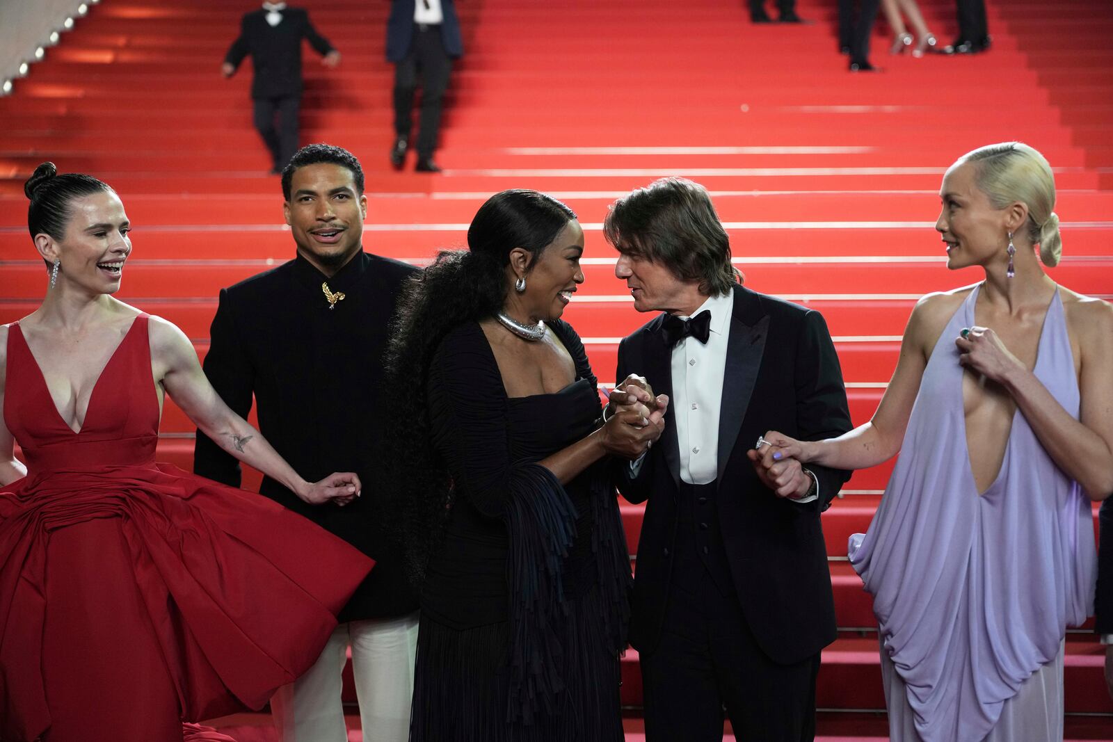 Hayley Atwell, from left, Greg Tarzan Davis, Angela Bassett, Tom Cruise, and Pom Klementieff pose for photographers upon departure from the premiere of the film 'Mission: Impossible – The Final Reckoning' at the 78th international film festival, Cannes, southern France, Wednesday, May 14, 2025. (AP Photo/Natacha Pisarenko)