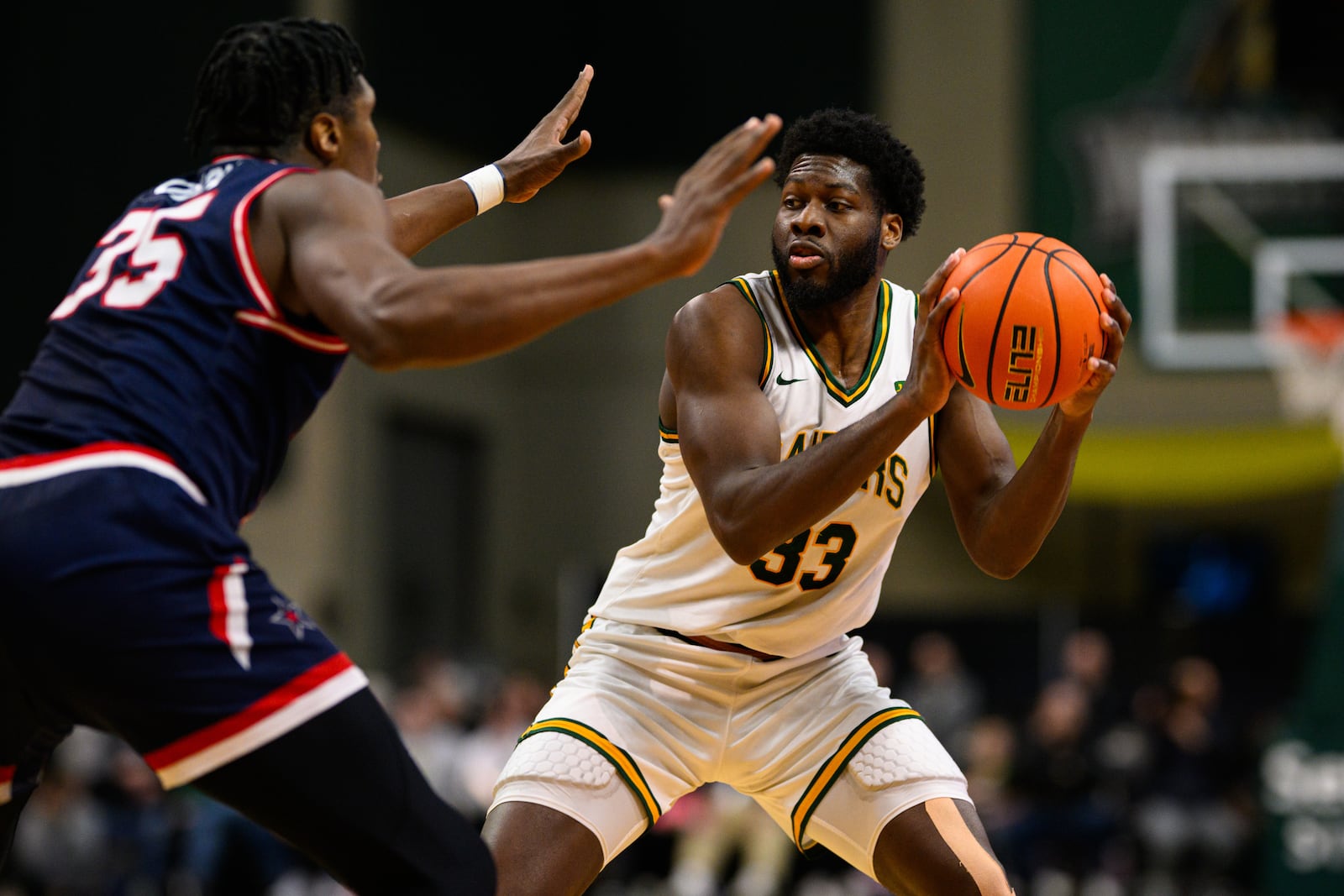Wright State University's Michael Imariagbe is guarded by Robert Morris University's Ubong Okon during their game on Sunday, Feb. 22, 2026 at the Nutter Center. JEREMY MILLER / CONTRIBUTED PHOTO