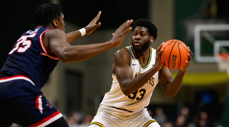 Wright State University's Michael Imariagbe is guarded by Robert Morris University's Ubong Okon during their game on Sunday, Feb. 22, 2026 at the Nutter Center. JEREMY MILLER / CONTRIBUTED PHOTO