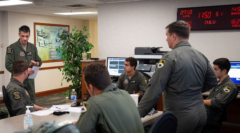 U.S. Air Force F-22 Raptor pilots brief in the Wright-Patterson Air Force Base operations building Aug.26 prior to taking off for home. (U.S. Air Force photo/R.J. Oriez)