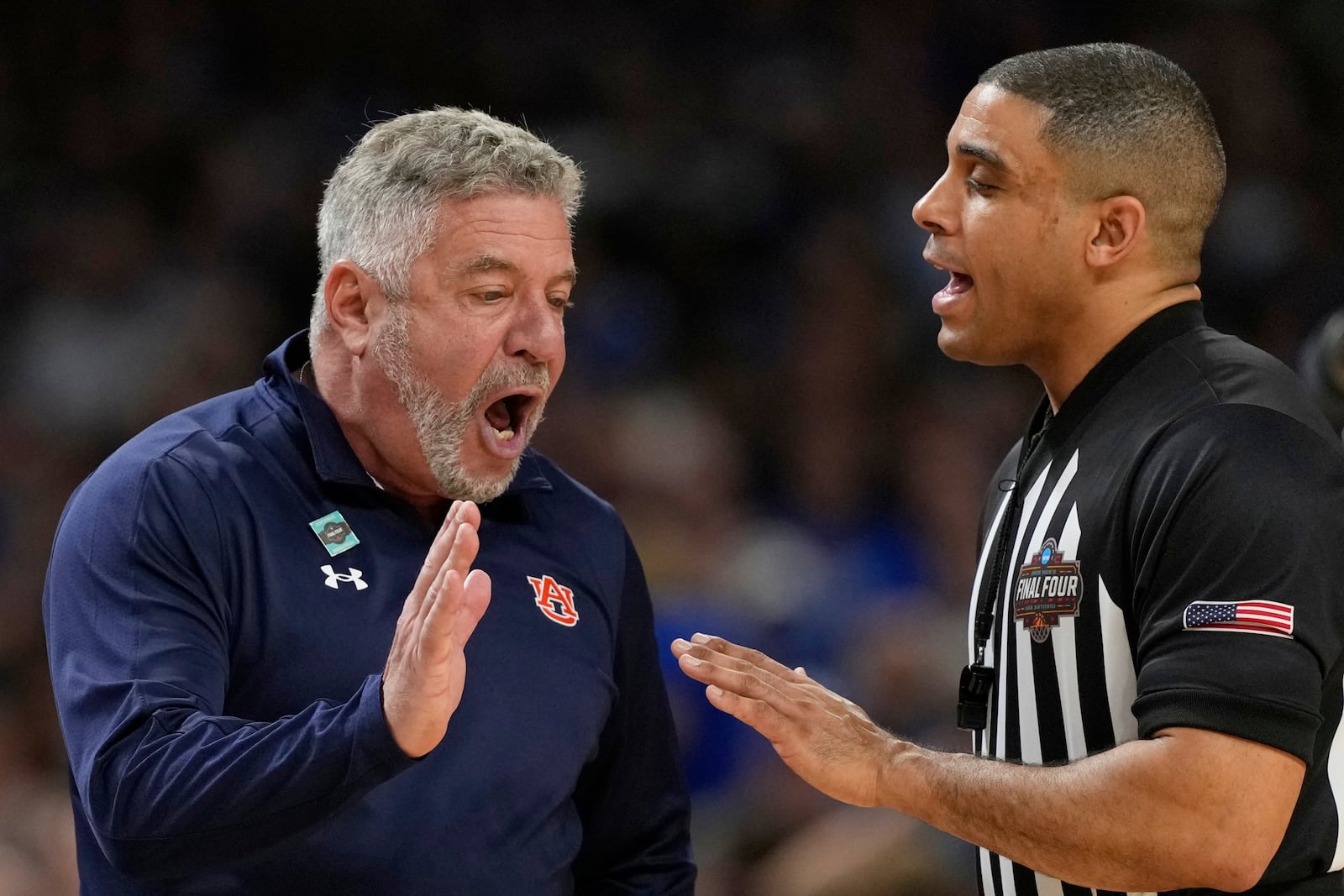 Auburn head coach Bruce Pearl, left, yells at an official during the second half in the national semifinals at the Final Four of the NCAA college basketball tournament, Saturday, April 5, 2025, in San Antonio. (AP Photo/Eric Gay)
