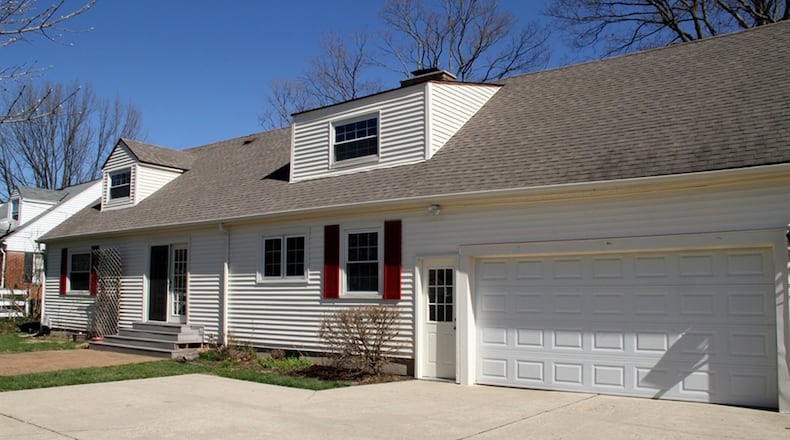 The house sits on a corner lot with a semi-private back yard, a rear-entry, 2-car garage, paver-brick patio and a corner koi garden pond.