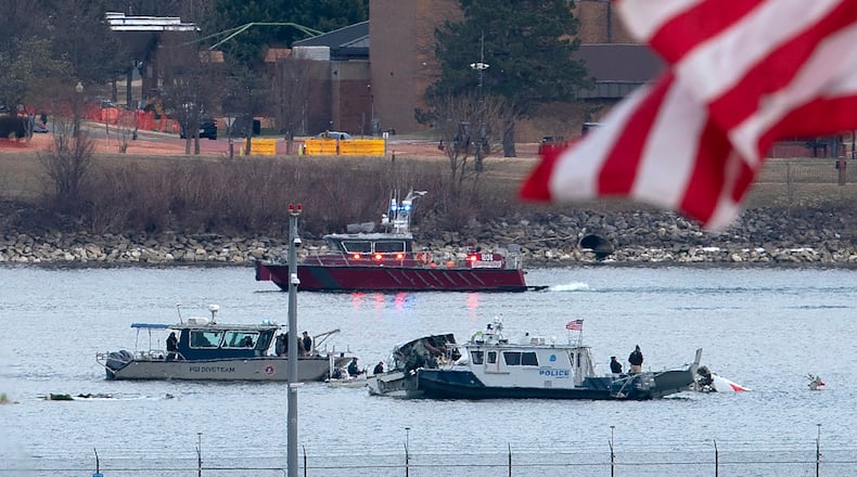 FILE - A diving team and police boat is seen near a wreckage site in the Potomac River, from Ronald Reagan Washington National Airport, Jan. 30, 2025, in Arlington, Va. (AP Photo/Jose Luis Magana, File)