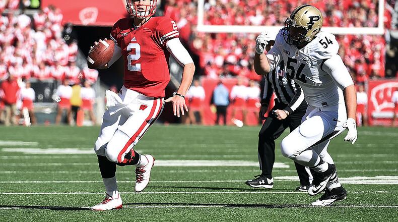 MADISON, WI - OCTOBER 17: Joel Stave #2 of the Wisconsin Badgers is pursued by Jake Replogle #54 of the Purdue Boilermakers during the first quarter of a game against the Purdue Boilermakers at Camp Randall Stadium on October 17, 2015 in Madison, Wisconsin. (Photo by Stacy Revere/Getty Images)