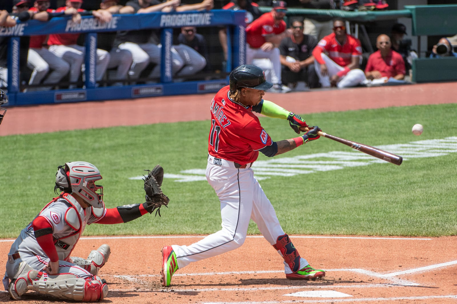Cleveland Guardians' Jose Ramirez hits an RBI double off Cincinnati Reds starting pitcher Nick Lodolo as catcher Jose Trevino works behind te plate during the first inning of a baseball game, Wednesday, June 11, 2025, in Cleveland. (AP Photo/Phil Long)