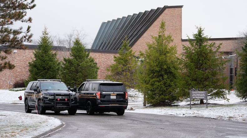 Police vehicles sit outside the Temple Israel synagogue Friday, March 13, 2026, in West Bloomfield Township, Mich. (AP Photo/Paul Sancya)