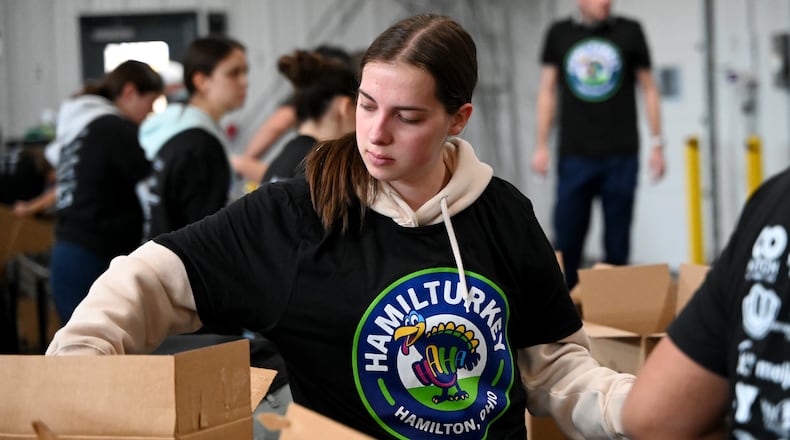 Shared Harvest saw about 30 volunteers from multiple organizations pack boxes on Friday, Nov. 14, 2025, for the annual Hamil-Turkey event, where thousands of people will be fed through these prepackaged Thanksgiving dinners. Hundreds of more people are expected to be fed at a Thanksgiving buffet dinner sponsored by various organizations. MICHAEL D. PITMAN/STAFF