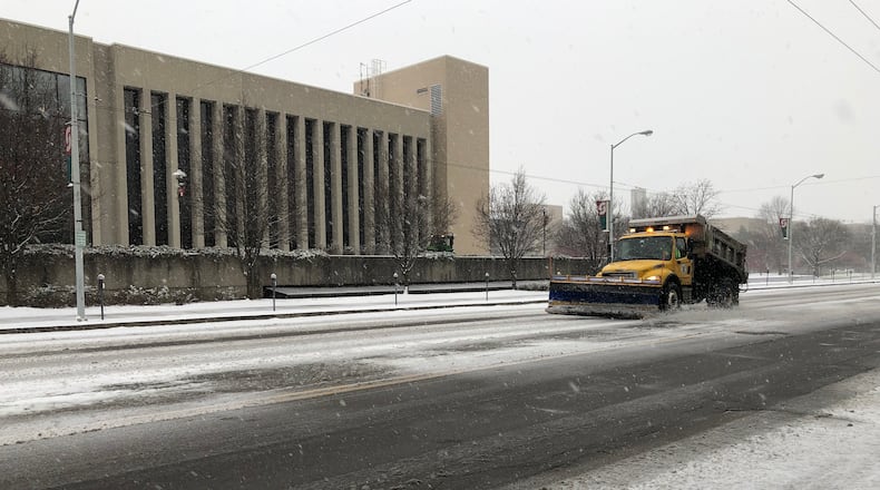 A city of Dayton plow hits the streets Saturday morning. STAFF/CORNELIUS FROLIK