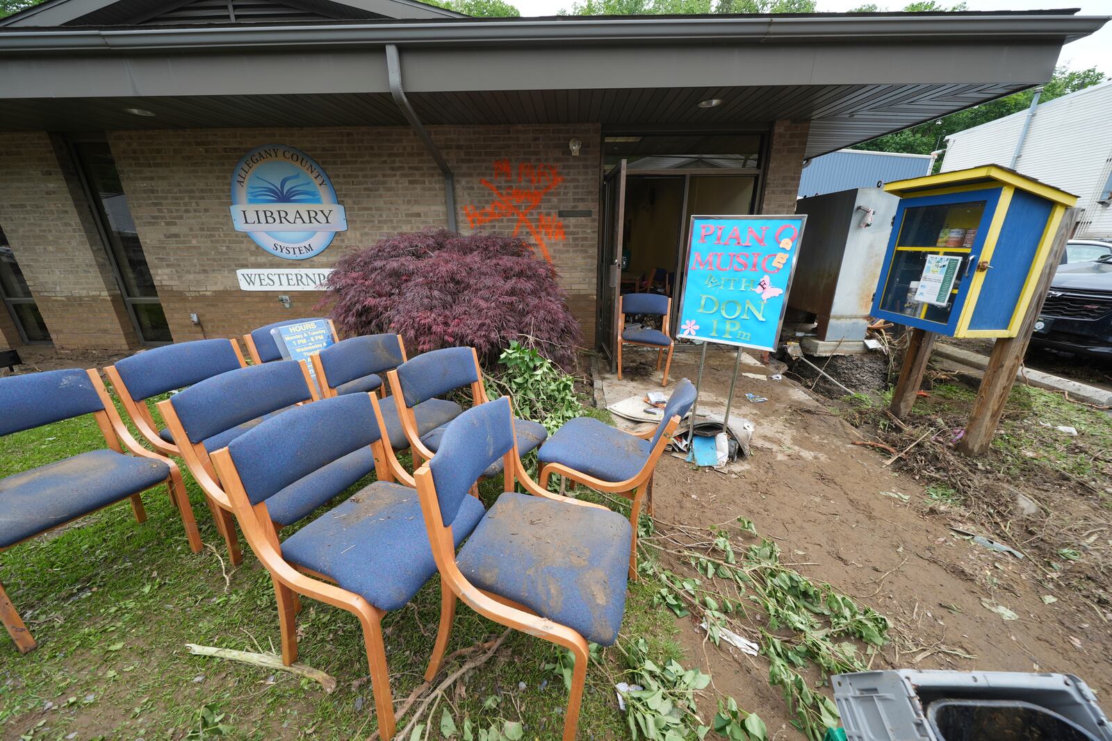 Furniture is placed outside the Westernport Library as clean up continues after flooding on Wednesday, May 14, 2025 in Westernport, Md. (AP Photo/Gene J. Puskar)