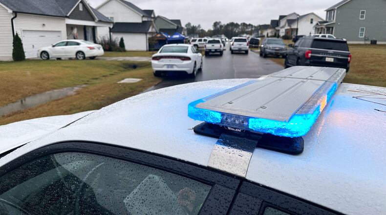 Law enforcement vehicles block the road to Wellington Delano Dickens III's home, where remains were found after Dickens told authorities he had killed four of his children, in Zebulon, N.C., on Tuesday, Oct. 28, 2025. (AP Photo/Allen G. Breed)