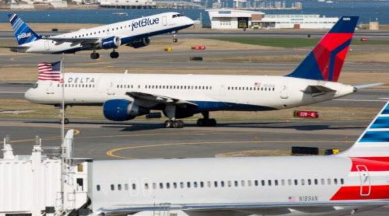 JetBlue, Delta and American airlines planes are seen at Boston's Logan International Airport on April 13, 2015.
