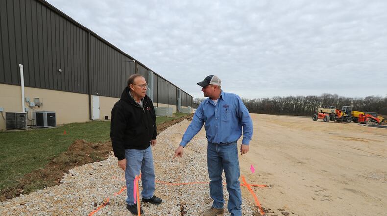 Tom Hensley and his son, Mark, owners of Fab Metals in New Carlisle, talk about the footers that are ready to pour for their new expansion which will more than double the size of their facility and could add as many as 20 to 25 new workers. Bill Lackey/Staff