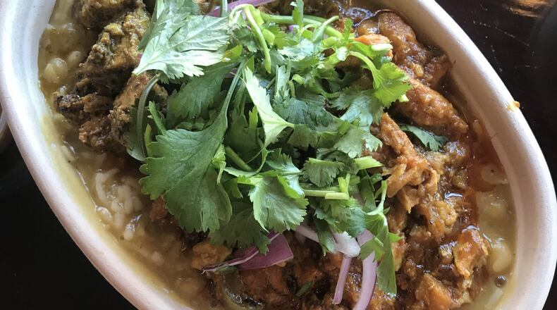 The Bridges Nepali Cuisine Rice Bowl is topped with your choice of Hakku Chuala (marinated chicken) or Chicken Tikka Masala (both toppings are pictured), and Aloo Wala (marinated potatoes). Hot or mild lentils and chutneys are served on the side. CONTRIBUTED