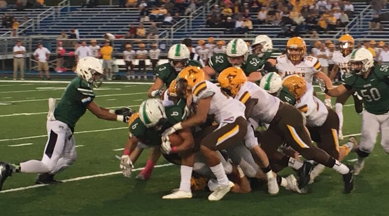 Badin’s Lavassa Martin (6) is brought down the Alter defense during a game earlier this season at Hamilton’s Virgil Schwarm Stadium. RICK CASSANO/STAFF