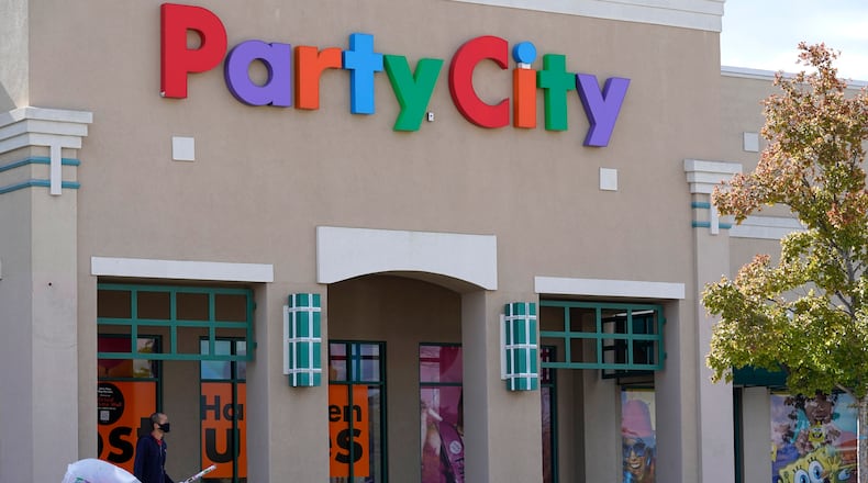 A shopper leaves a Party City store in Vernon Hills, Ill., Thursday, Oct. 15, 2020. The party supplies chain has been long struggling with increased competition from the likes of Walmart and Target. (AP Photo/Nam Y. Huh, File)