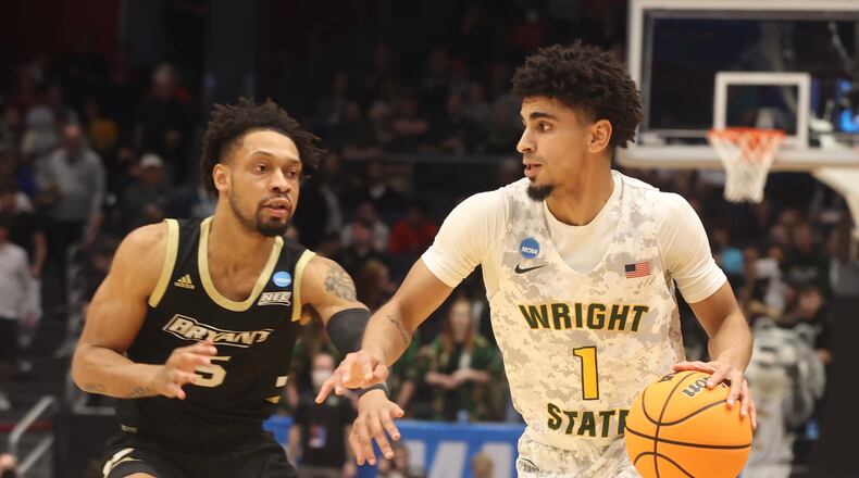 Wright State’s Trey Calvin works around Bryant’s Charles Pride Wednesday, March 16, 2022 during a NCAA First Four game at UD Arena. BILL LACKEY/STAFF