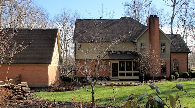 A screen-enclosed porch is accessible from the breakfast room and opens to a paver-brick patio and fenced back yard. The property extends past the corral fence with mature trees and a fire pit. There is also a 2-car, heated, detached garage, which has a floored attic space.