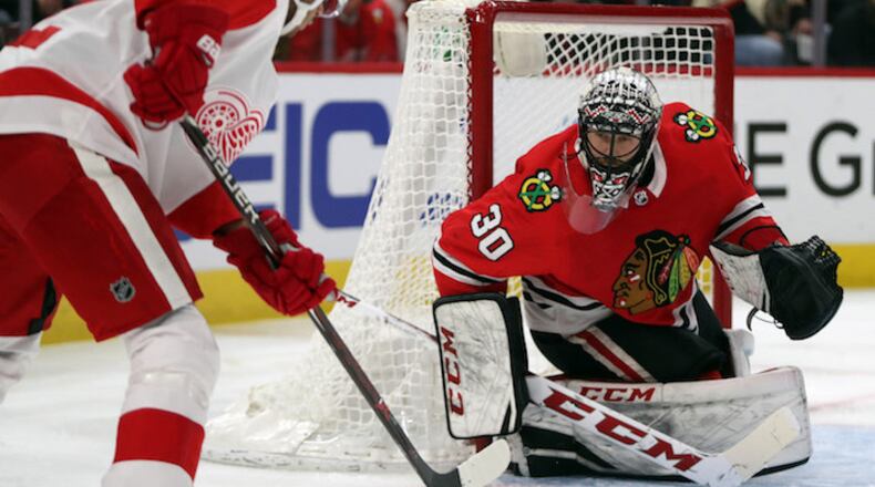 Chicago Blackhawks goaltender Jeff Glass (30) protects the net against Detroit Red Wings left wing Andreas Athanasiou (72) on January 14, 2018, at the United Center in Chicago. (Brian Cassella/Chicago Tribune/TNS)