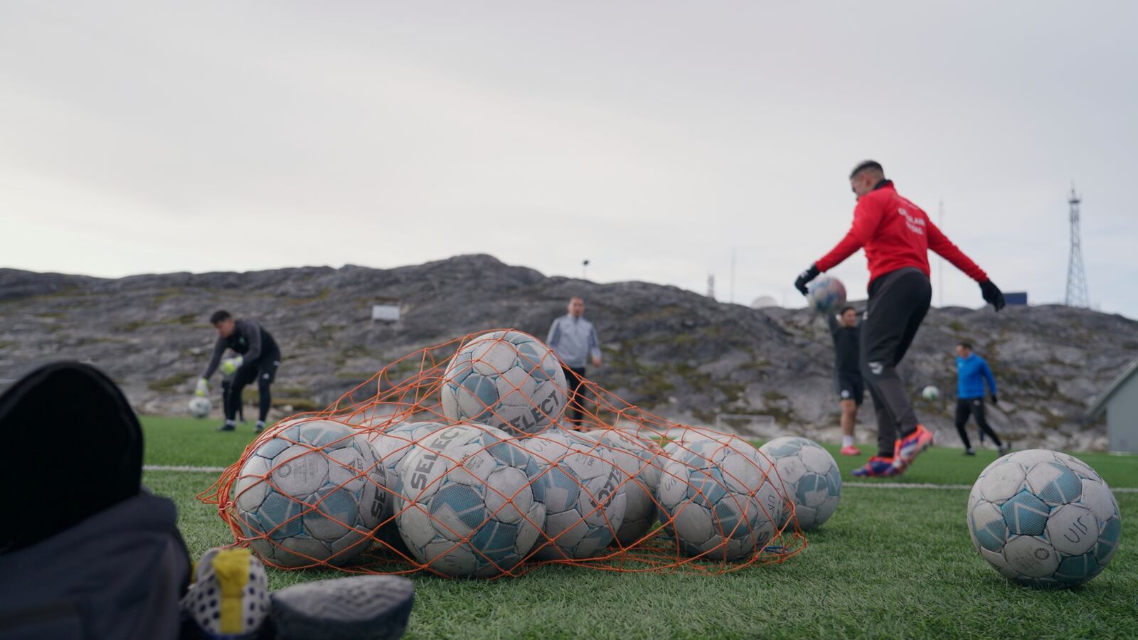 Soccer balls lie on a pitch of Nuuk stadium in Nuuk, Greenland, Tuesday, June 17, 2025. (AP Photo/Kwiyeon Ha)