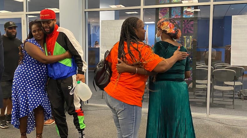 Members of the public from Residence Park and advocates for a school for immigrant kids celebrate after the Dayton Public Schools board unanimously voted to reopen a West Side school in Residence Park for both the neighborhood and as a school to welcome immigrant students. Eileen McClory / Staff
