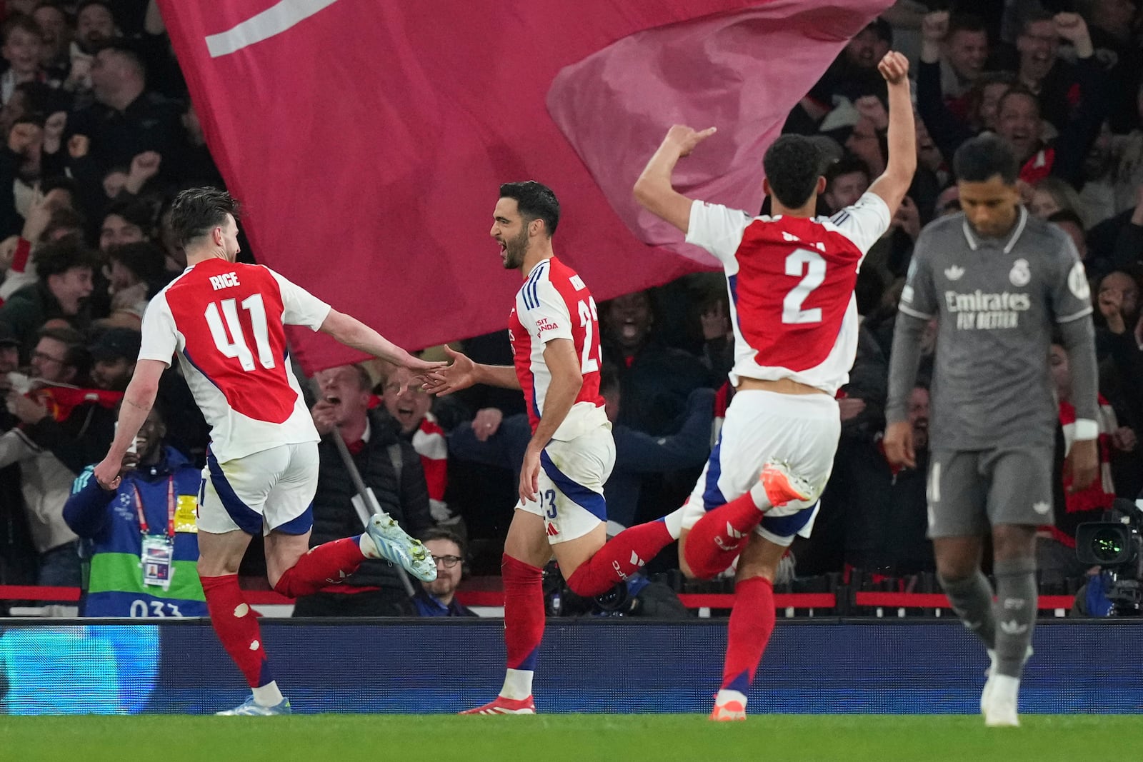 Arsenal's Mikel Merino, second left, celebrates with his teammate Declan Rice after scoring his side's third goal during the Champions League quarterfinal first leg soccer match between Arsenal and Real Madrid at the Emirates Stadium in London, Tuesday, April 8, 2025. (AP Photo/Frank Augstein)