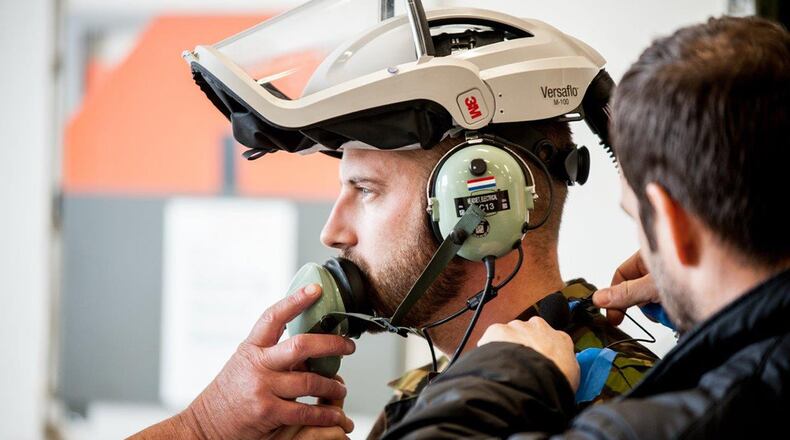 A Dutch bioenvironmental engineer attaches microphones to an F-35 maintainer prior to a testing session, led by acoustics experts in the Air Force Research Laboratory’s 711th Human Performance Wing. Other members of the international team test air quality, all in efforts to provide a report about the safety of personnel and F-35s inside the hardened aircraft shelter. (Courtesy photo/Royal Netherlands Air Force)