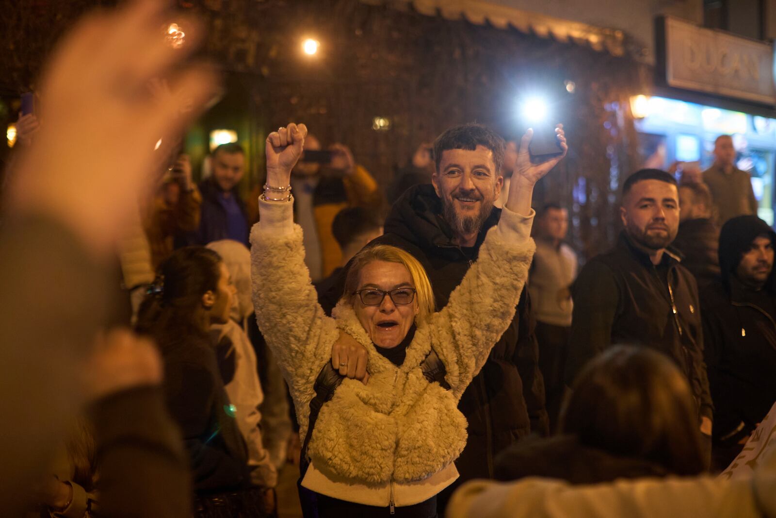Locals greet a group of students who walked across the country as they arrive at an anti-corruption protest in the southwestern town of Novi Pazar, Serbia, Friday, April 11, 2025. (AP Photo/Marko Drobnjakovic)