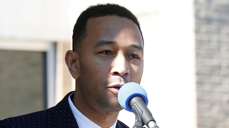 John Legend speaks to the crowd before cutting the ribbon for the new John Legend Theater in Springfield. Bill Lackey/Staff