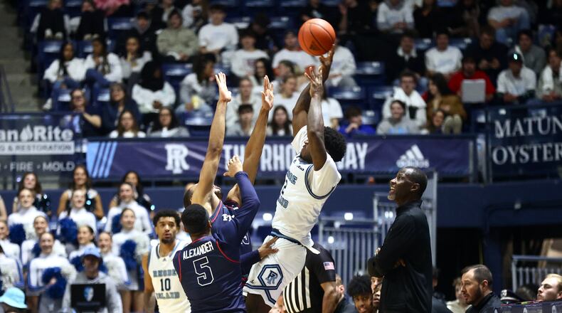 Dayton's Posh Alexander, front, and Zed Key, back center, apply pressure against Rhode Island's Jaden House on Wednesday, Feb. 26, 2025, at the Ryan Center in Kingston, R.I. David Jablonski/Staff