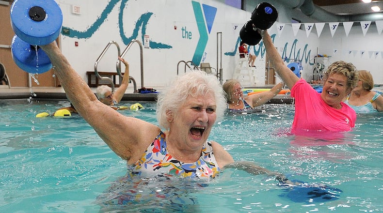 Marilyn Specht, 84, left, works with her instructor Sandy Bakos, during a water exercise class Tuesday Feb. 29, 2023. 
Specht goes 5 times a week to the Kleptz YMCA in Englewood. MARSHALL GORBY\STAFF