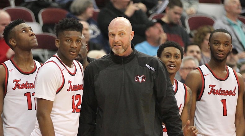 Trotwood-Madison’s Rocky Rockhold, third from right, and his players watch the final seconds of a victory against Meadowbrook in a Division II state semifinal on Friday, March 23, 2018, at the Schottenstein Center in Columbus. David Jablonski/Staff