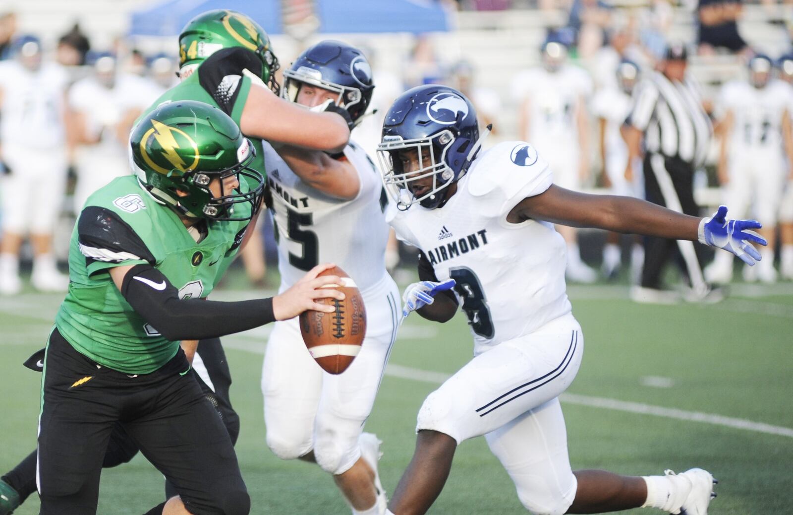 Northmont quarterback Miles Johnson eludes Fairmont’s Kahil Jones-Whitaker. Northmont defeated visiting Fairmont 24-21 in a Week 2 high school football game that was suspended on Friday due to weather delays and completed on Saturday, Sept. 1, 2018. MARC PENDLETON / STAFF