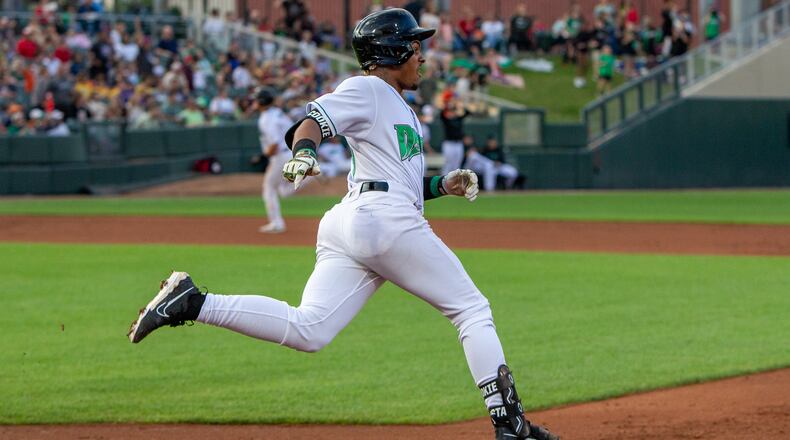 Dragons second baseman Victor Acosta sprints around first base on his way to a second-inning triple as Cade Hunter heads for third and eventually home for the Dragons' first run Saturday night at Day Air Ballpark. Jeff Gilbert/CONTRIBUTED