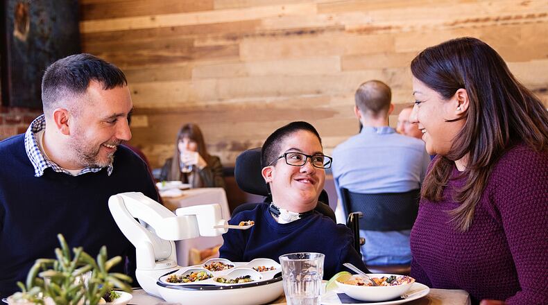 Obi is a Dayton-made robotic device that restores a more independent dining experience for individuals that lack upper extremity function. The robot has an attached, jointed arm can be programmed to lift a magnetized spoon filled with food from one of Obi’s compartments or bowls to a person’s mouth. CONTRIBUTED