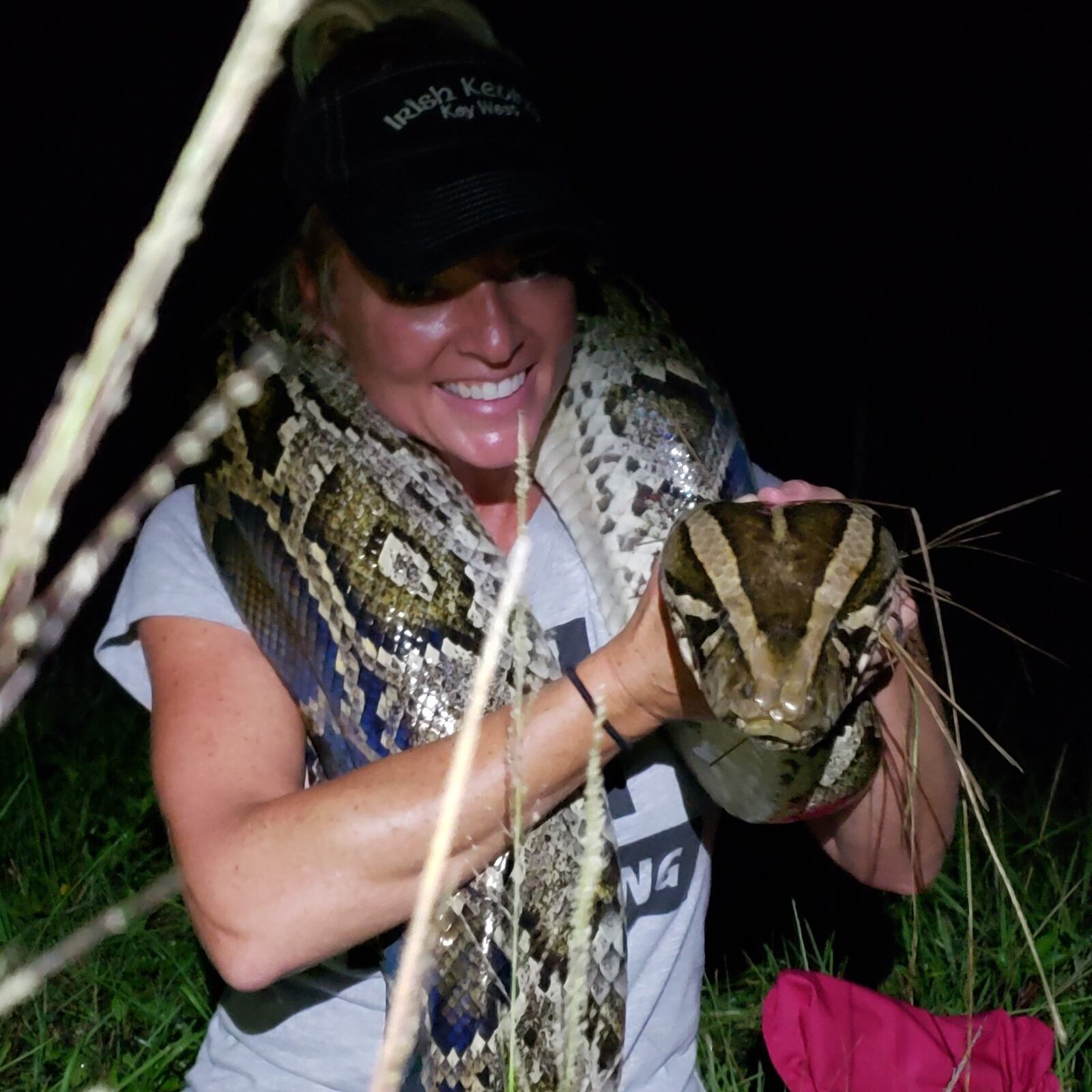 -- Amy Siewe holds out the gigantic head of the 17-foot-3 inch python she captured last July of the Tamiami Trail in the Everglades. Amy, a former Fairmont High athlete and Homecoming queen and University of Toledo tennis player, is now a python hunter contracted by the South Florida Water Management District to help rid the Everglades of the invasive pythons that are killing all the animals and birds they come in contact with and wrecking the ecosystem. CONTRIBUTED