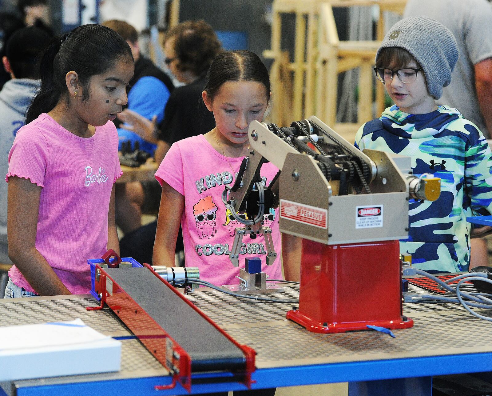 Coding a robot arm Thursday, June 13, 2024 at the first career camp for middle school students at the Greene County CTC are from left, Dhruvika Tharigo, Olivia Wagstron and Trey Ford. A total of 85 middle school students signed up for the camp. MARSHALL GORBY\STAFF



