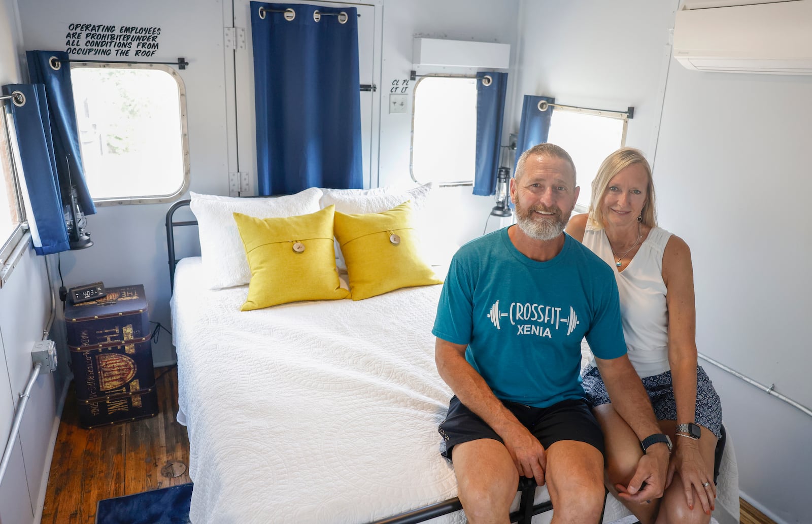 Ray and Karen DeVite pose for a portrait in the bedroom of a caboose they turned into an Airbnb on Monday, September 15, 2025, in Xenia. JOSEPH COOKE/ STAFF