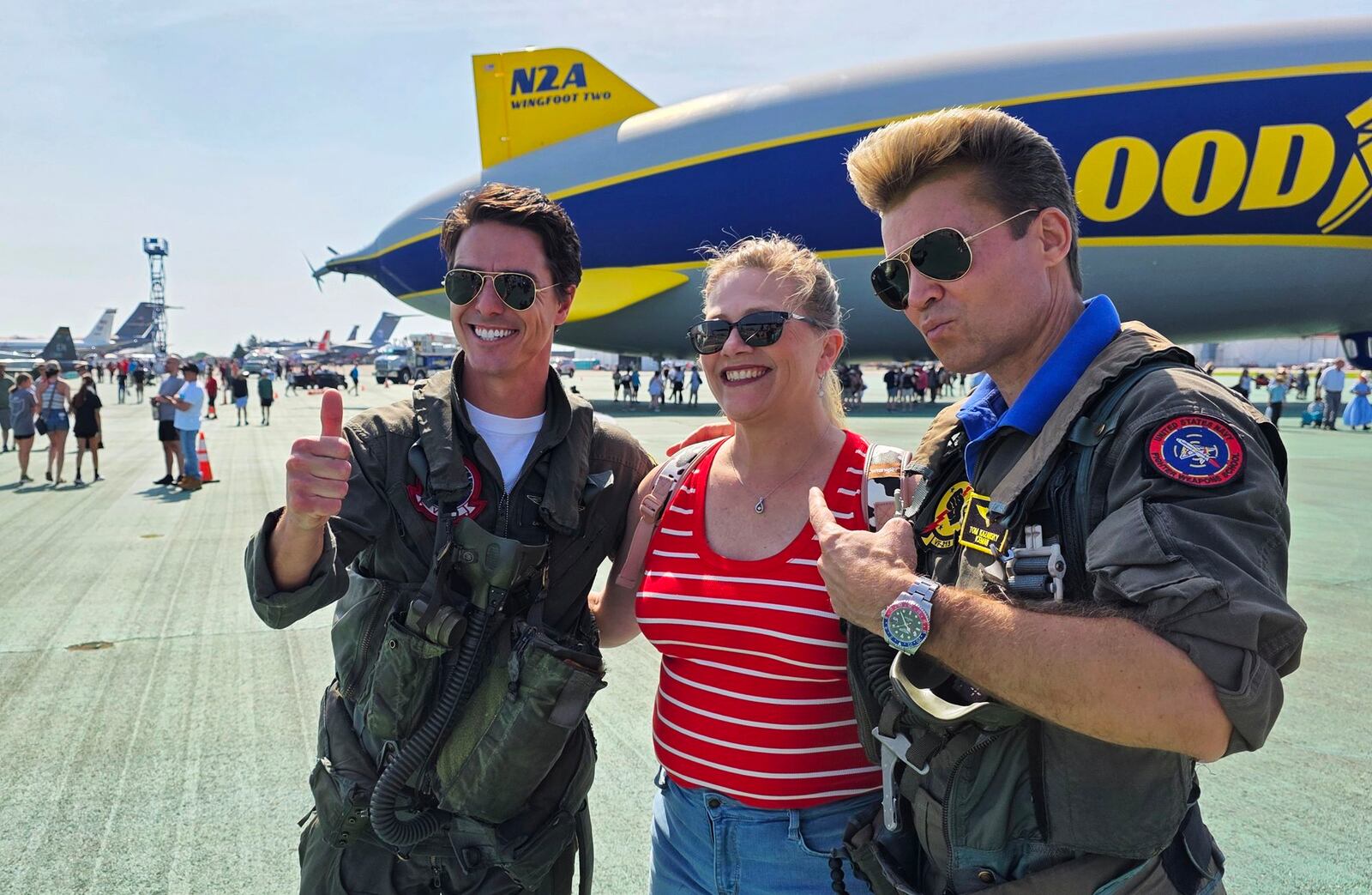 Beth Lukens gets her photo taken with Macerick and Iceman impersonators during the CenterPoint Energy Dayton Air Show Saturday, June 21, 2025 at Dayton International Airport. NICK GRAHAM/STAFF